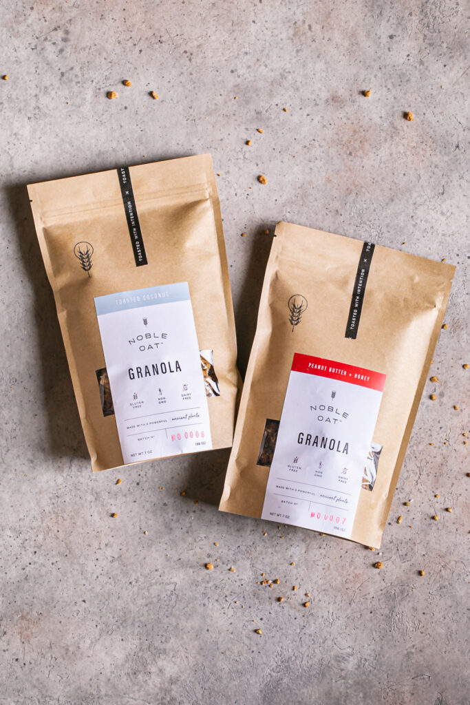 two bags of noble oat granola in toasted coconut and peanut butter honey flavors