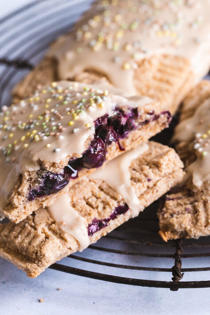 a close up of the blueberry inside of a pop tart frosted and sprinkled