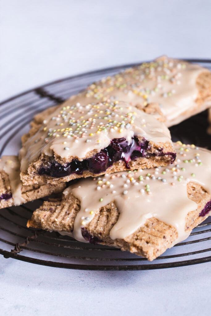 a close up of the blueberry inside of a pop tart frosted and sprinkled