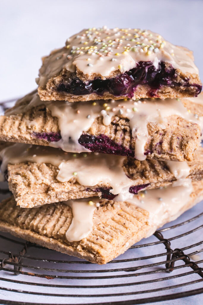 a close up of blueberry lemon pop tarts stacked on top of one another