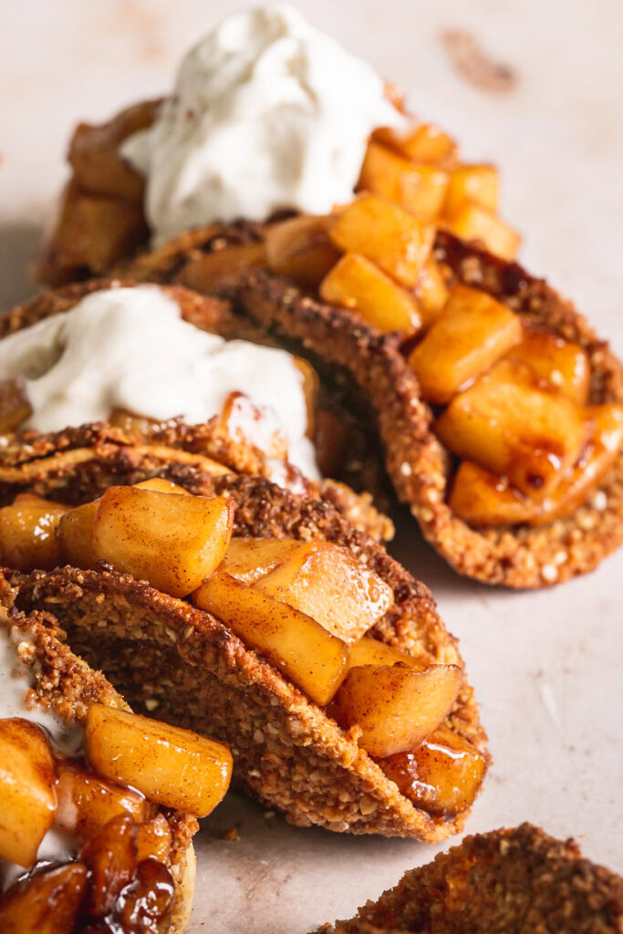 close up side view of apple pie tacos with partially melted ice cream