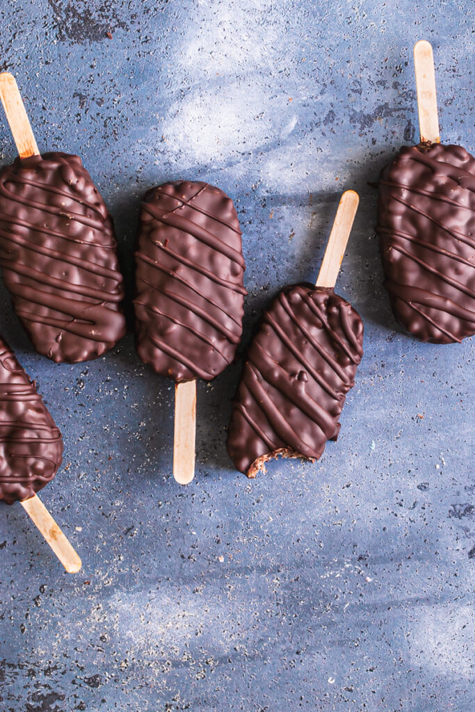 chocolate covered cocoa Krispie crunch pops lined up next to each other