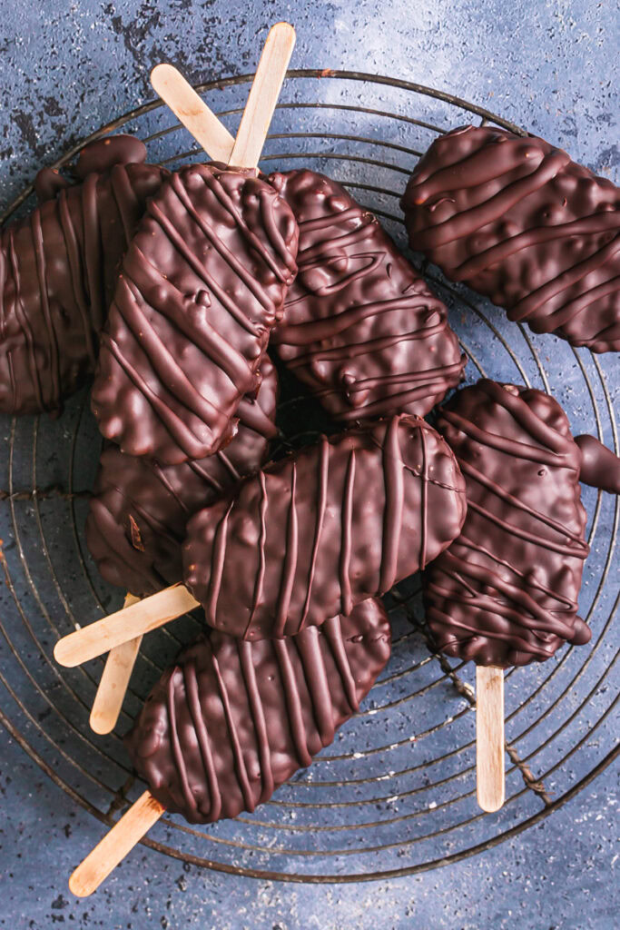 chocolate covered krispy crunch pops stacked on top of one another