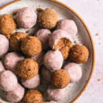 close up of strawberries and cream granola bites one with a bite taken out of it