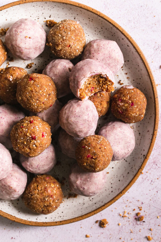 close up of strawberries and cream granola bites one with a bite taken out of it