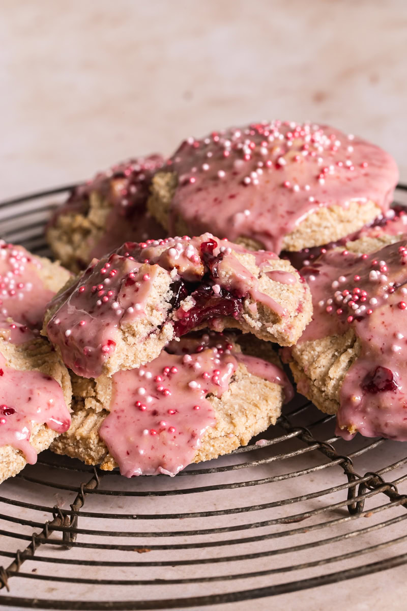 a head on image of cherry pop tarts with a bite out of the front one revealing the cherry filling