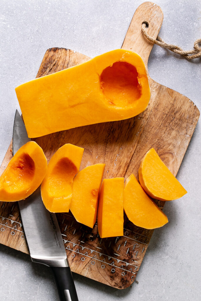 half of the butternut squash cut in slices