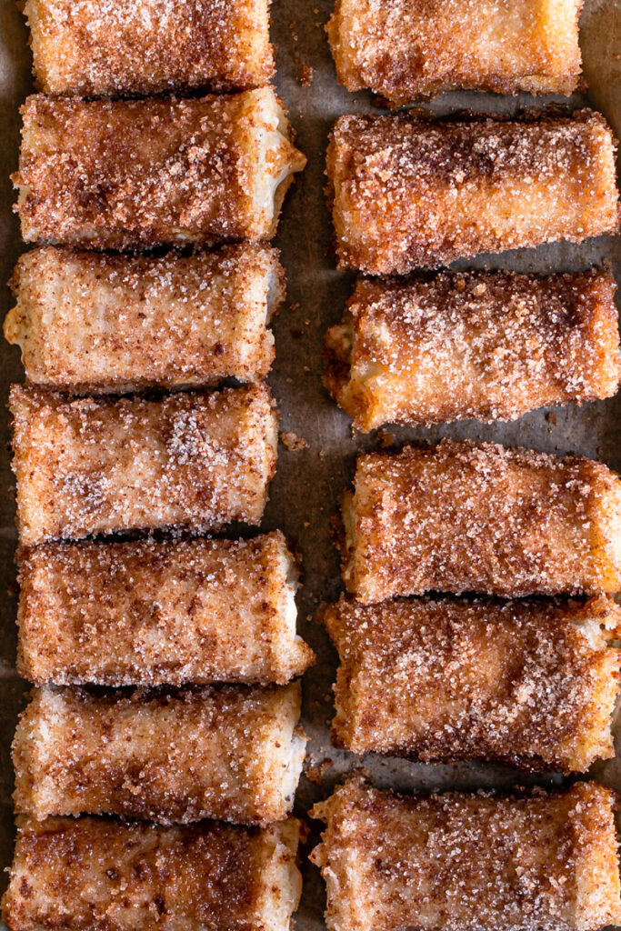 an overhead shot of Pumpkin Cream Cheese Rollups lined up on a baking sheet