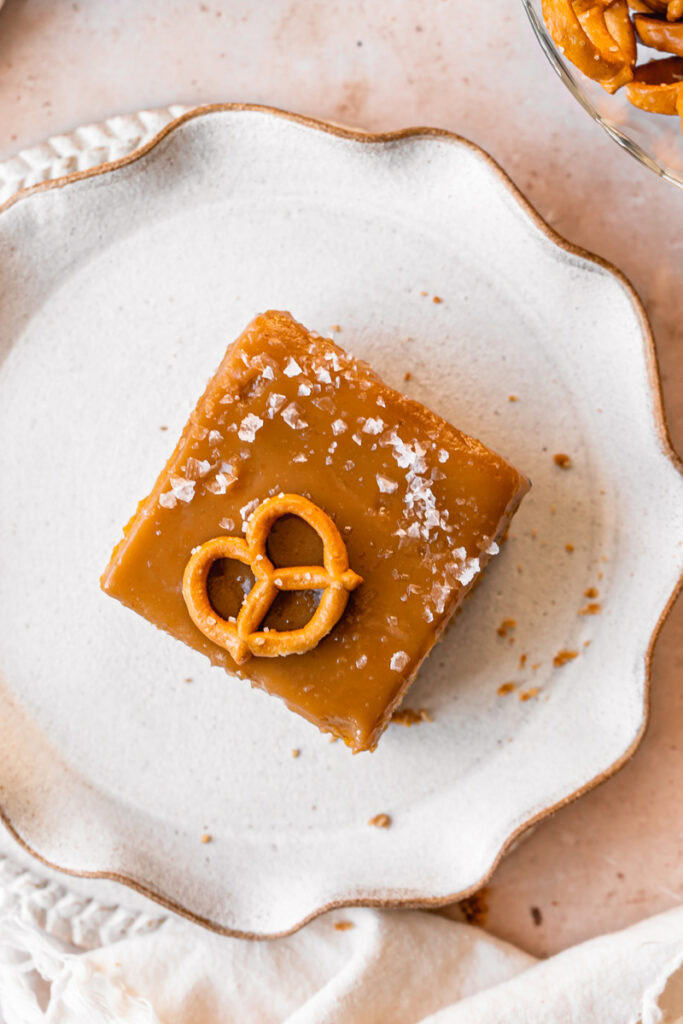 overhead shot of a slice of Salted Caramel Pumpkin Pie Bars with Pretzel Crust on a plate