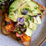 a close up of a slice of Bruschetta Avocado Toast