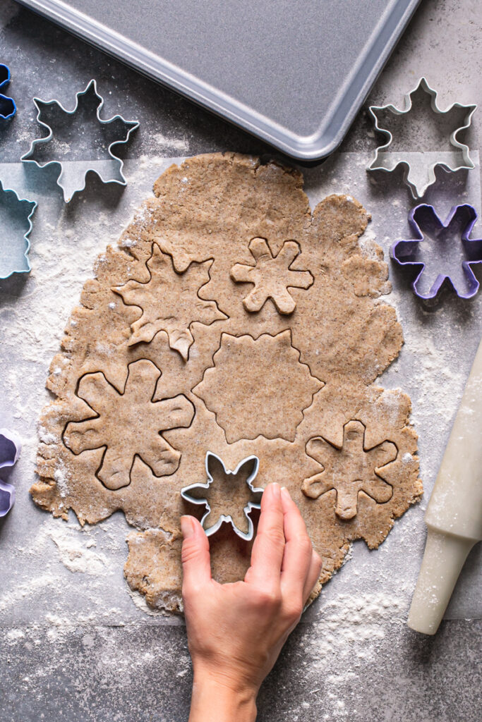 action shot of cutting the snowflake shapes out of the dough