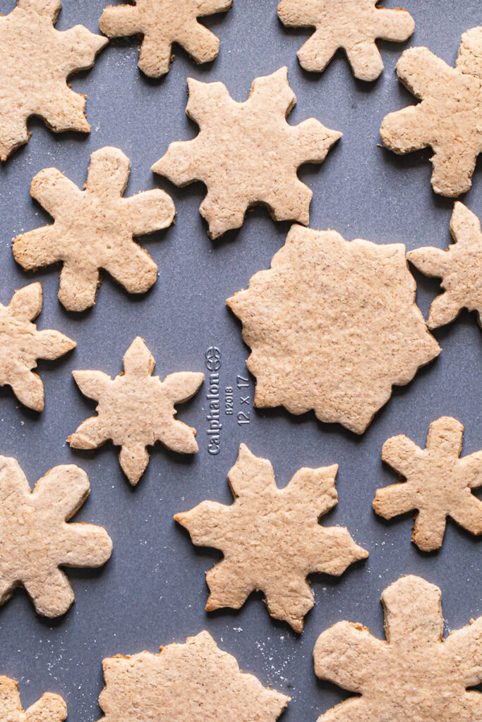 un-iced baked sugar cookies on a Calphalon baking sheet
