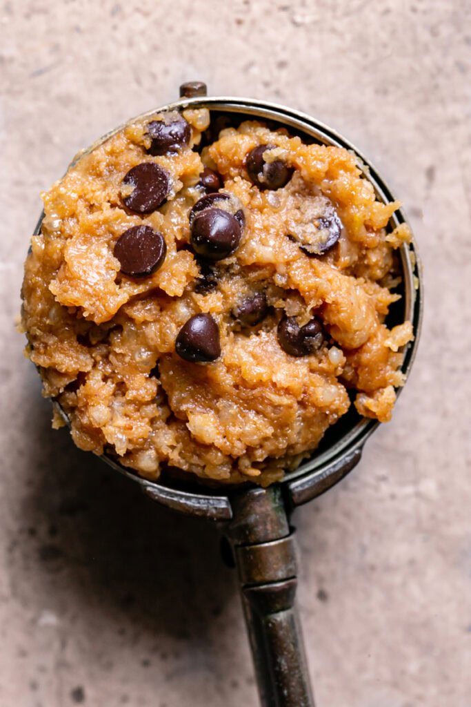 an ice cream scoop with quinoa chocolate chip cookie dough in it
