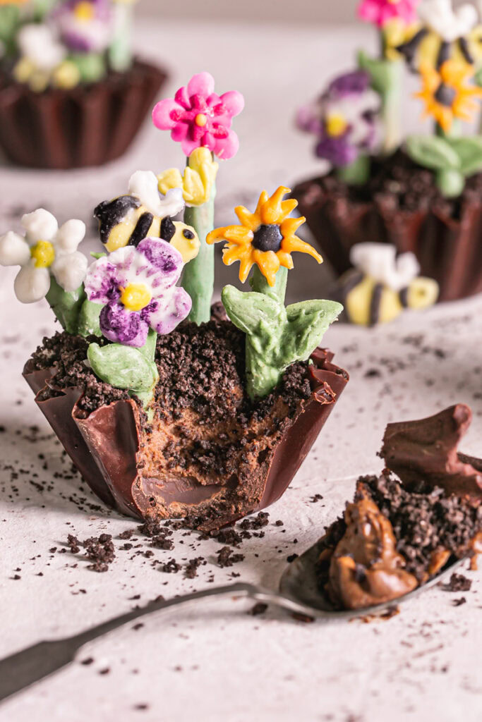 a close up of a Chocolate Avocado Pudding Dirt Cup with a scoop taken out of it