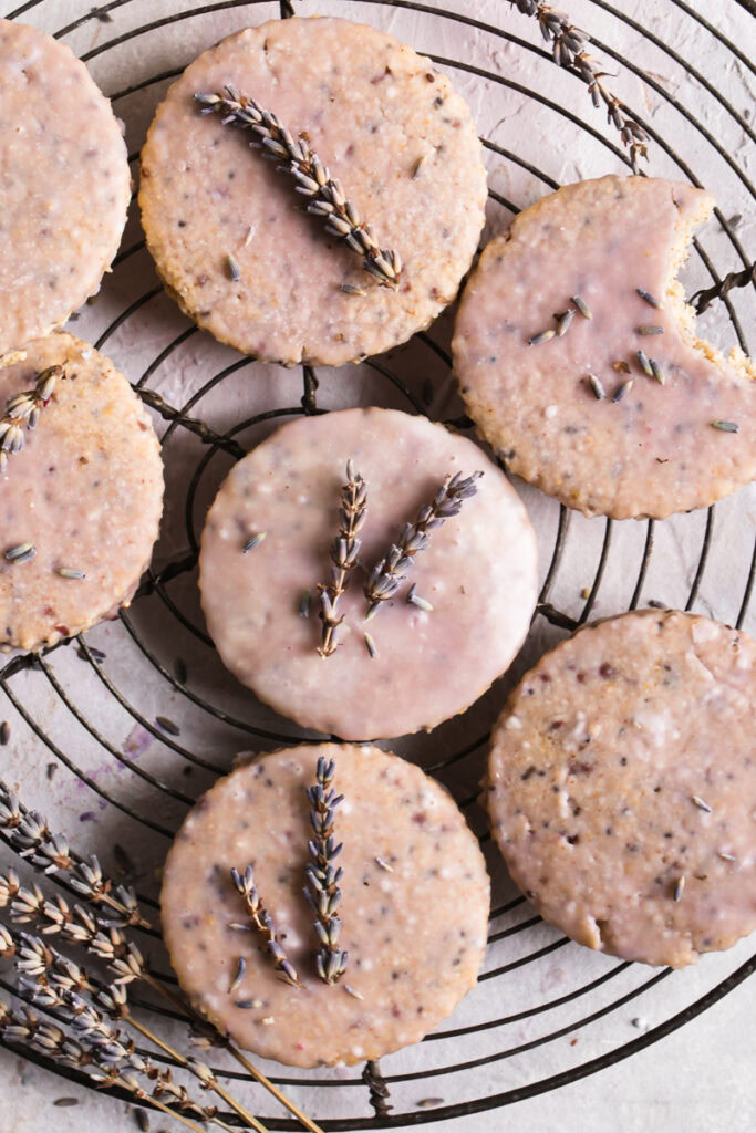 Lavender Vanilla Oatmeal Shortbread Cookies laid out on a round wire cooling rack with sprigs of lavender on top