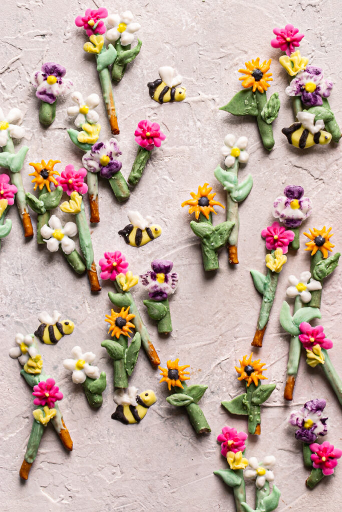 flowers and bees painted with food colored vegan white chocolate