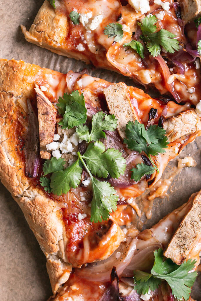 close up of a slice of Vegan BBQ Chicken Pizza
