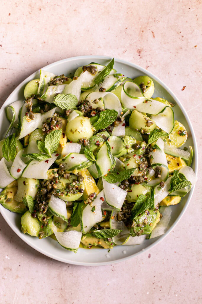 a plate filled with Honeydew Avocado Cucumber Crudo