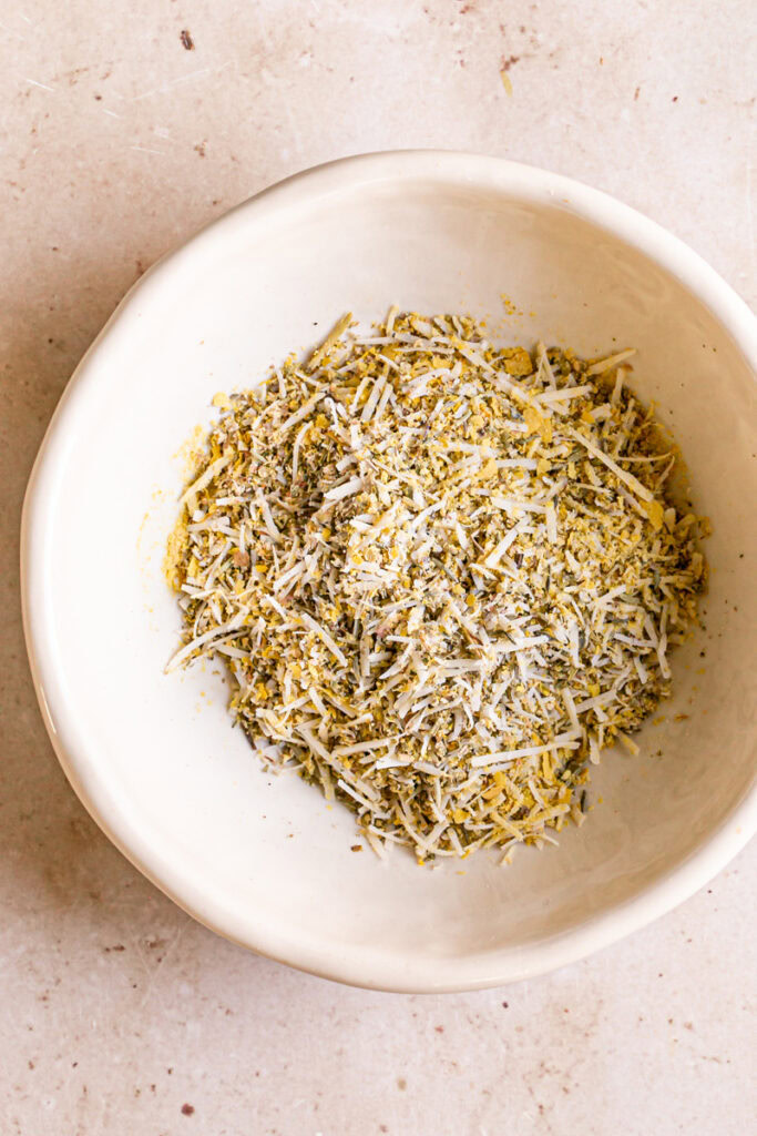 Italian seasoning, vegan parmesan cheese, nutritional yeast and salt mixed together in a bowl