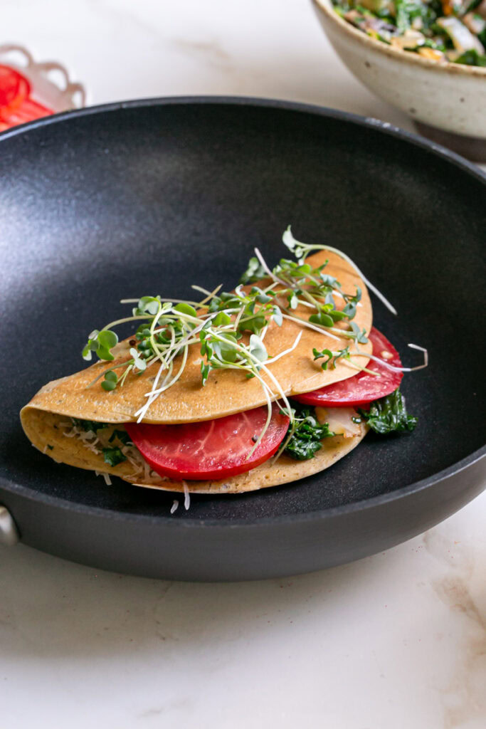 close up 3/4 view of a vegan gluten-free savory pancake in the pan