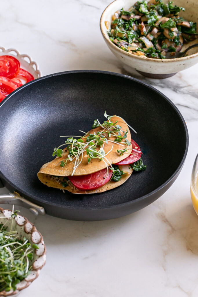 3/4 view of a vegan gluten-free savory pancake in the pan