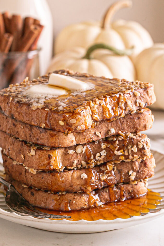 a close up of the stack of French toast slices with syrup dripping down the side