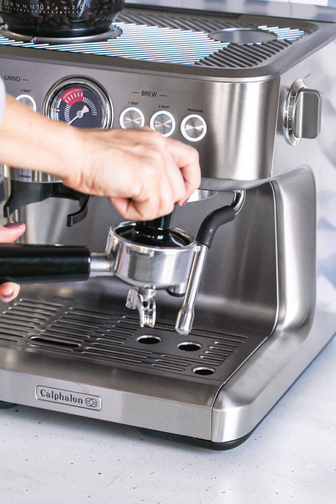 tamping the shot of espresso with the calphalon tamper