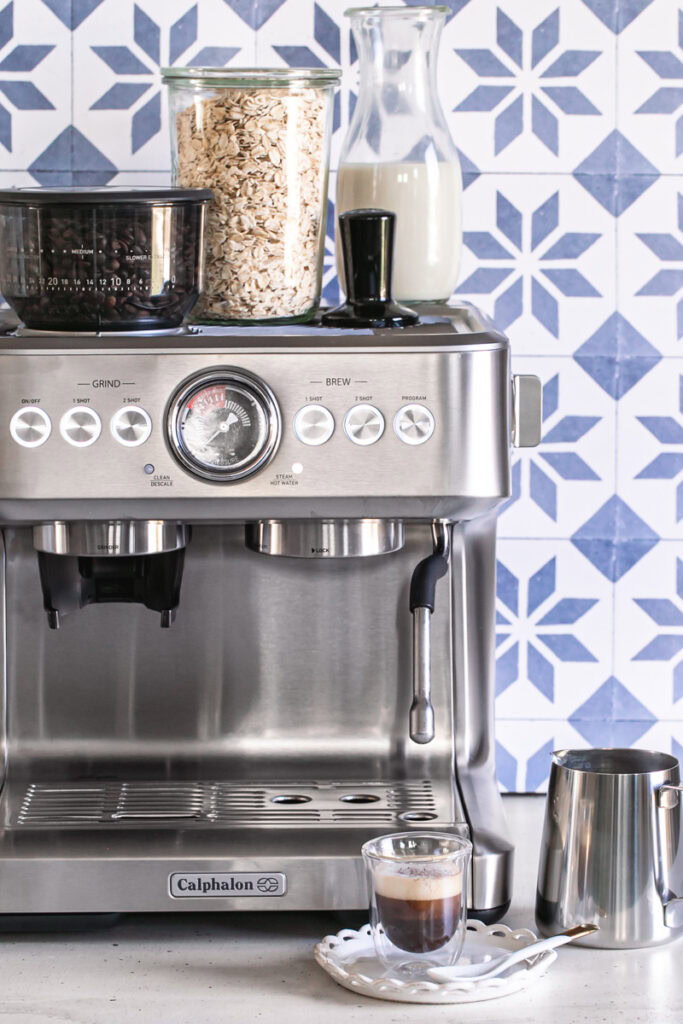 Calphalon espresso machine with a glass of espresso in front of it