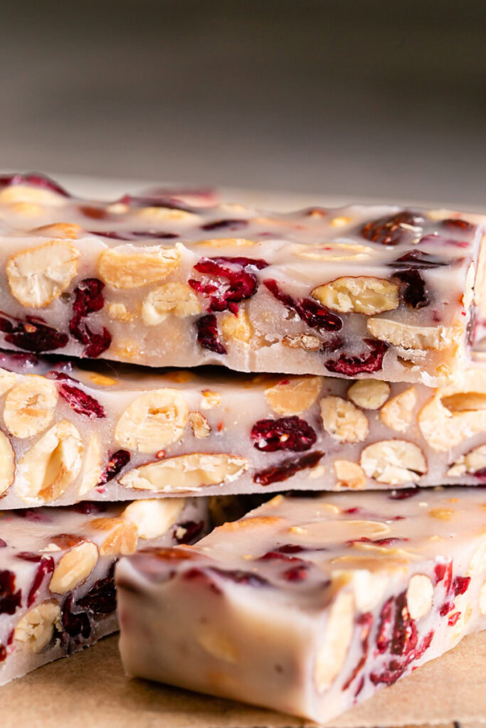 close up of sliced White Chocolate Amaretto Trail Mix Truffle Bars stacked on top of each other