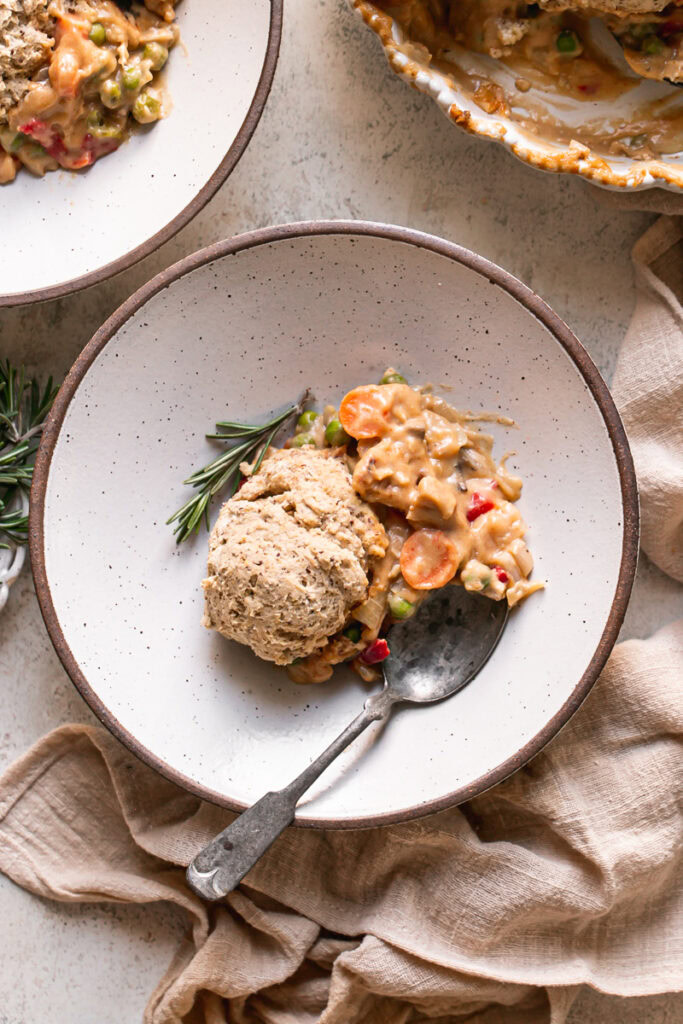 a bowl of vegan chicken pot pie casserole with a spoon in it