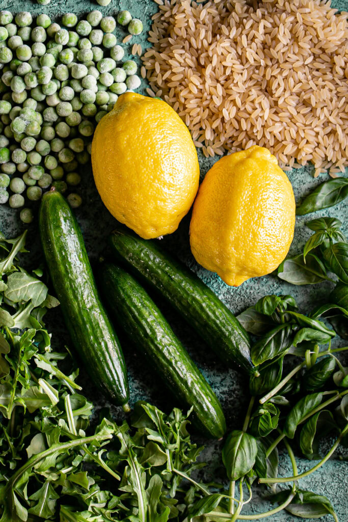 the fresh ingredients to make this lemon basil orzo salad. Two lemons, frozen peas, uncooked gluten-free orzo, 3 mini cucumbers, fresh baby arugula leaves, fresh basil leaves