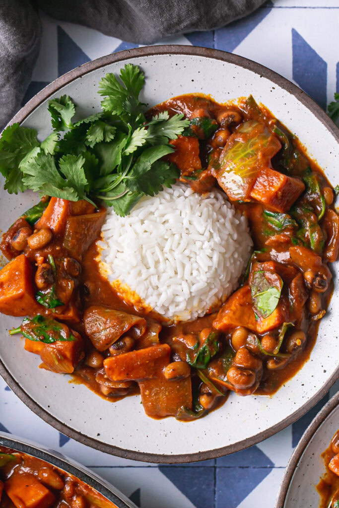 a close up of a bowl of sweet potato black eyed pea curry