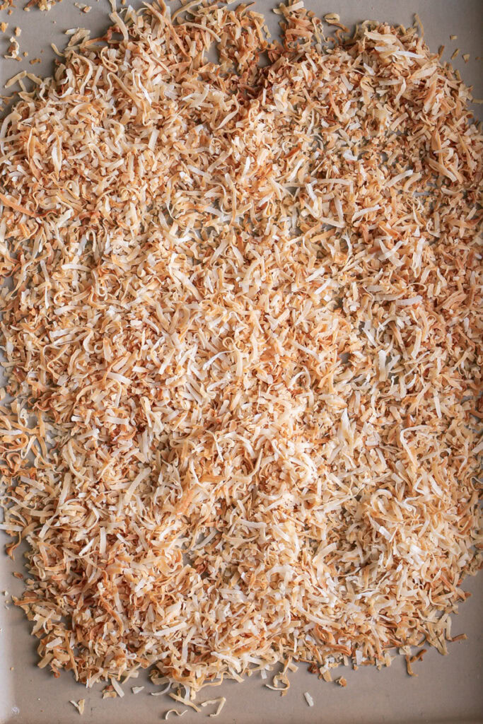 toasted coconut flakes on a baking sheet