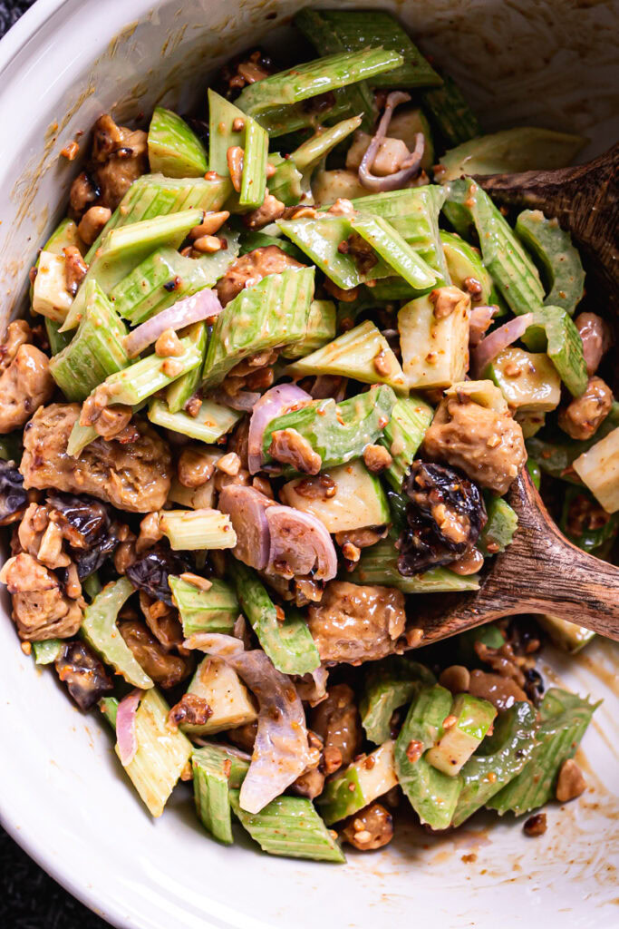 Ants On A Log Celery Chicken Salad mixed in a large bowl with a wooden spoon in the bowl