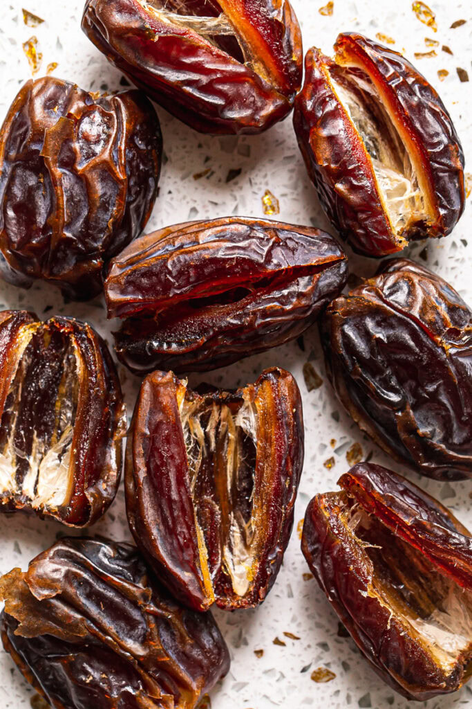 pitted dates on a speckled cutting board