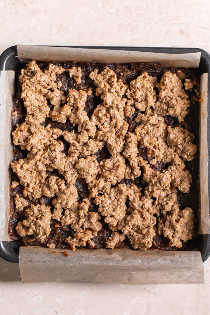 the peanut butter oat crust crumbled over the dates