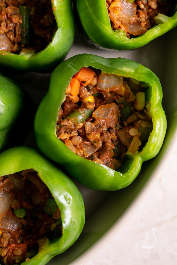 raw green bell peppers filled 3/4 way with shepherd's pie lentil filling