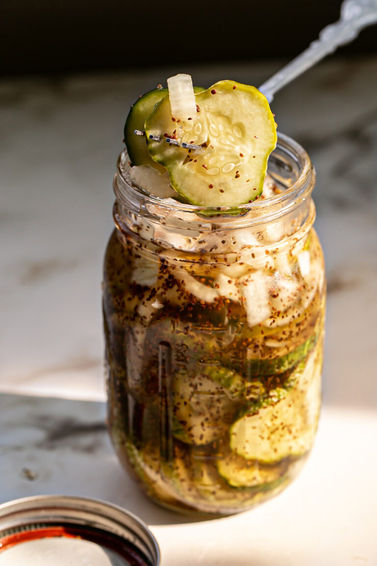 action shot of pulling some sweet pickles out of the jar with a fork