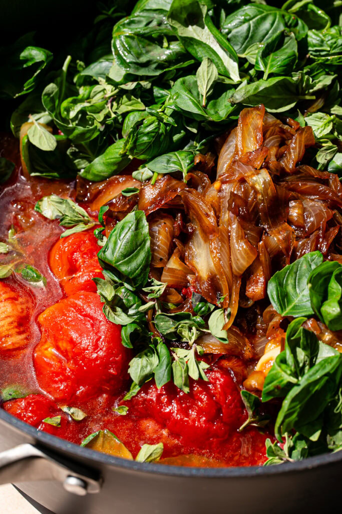 roasted tomatoes, caramelized onions, fresh basil and oregano added to a large pot