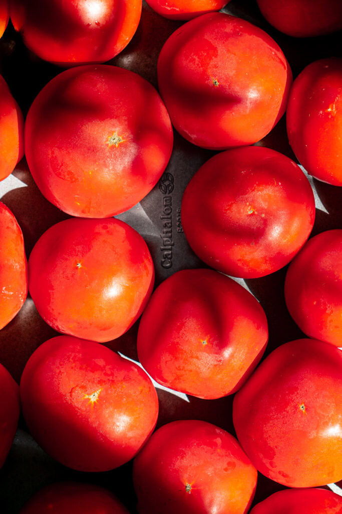 a baking sheet filled with large tomatoes from the garden