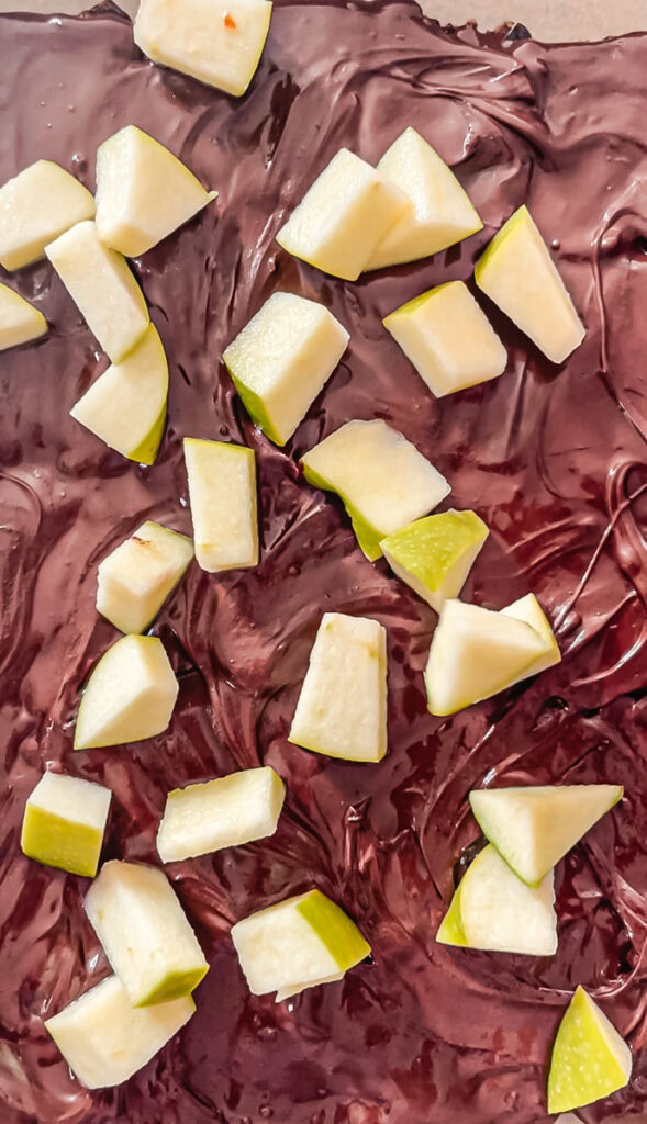 chopped green apple on top of the melted chocolate layer