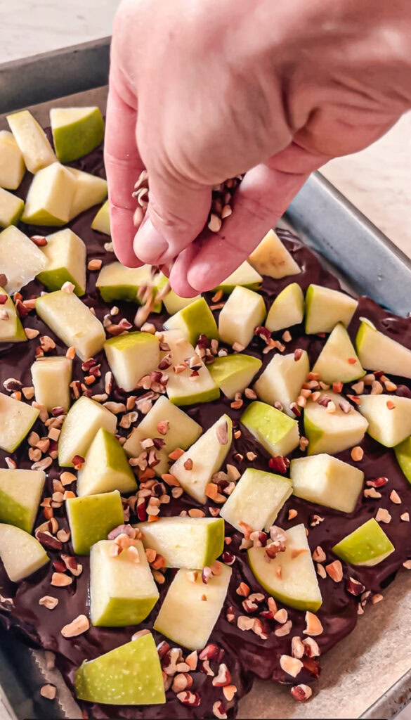 sprinkling chopped peanuts and pecans over the date bark