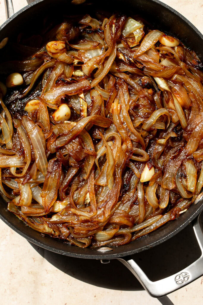overhead shot of a skillet of caramelized onions and garlic