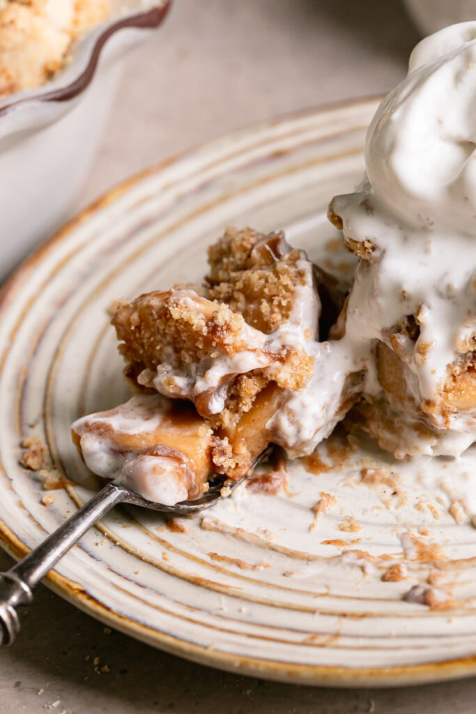 a close up of dutch apple pie on a fork
