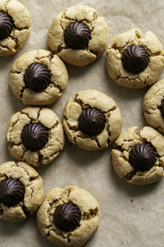 an overhead shot of Almond Flour Peanut Butter Blossom Cookies on a piece of parchment paper.