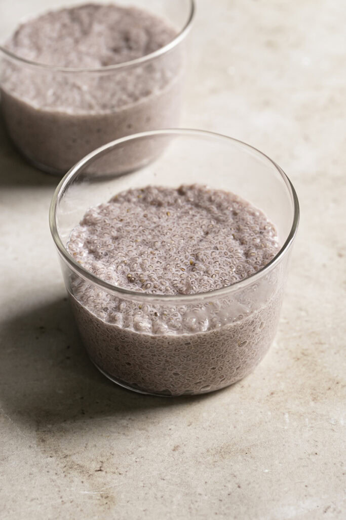 the strawberry hibiscus chia seed pudding divided up between two glasses.