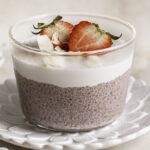 a very close up image of one glass of strawberry hibiscus chia seed pudding.
