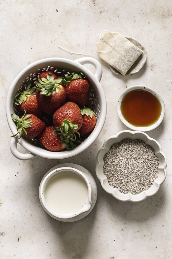 all the ingredients used to make strawberry hibiscus chia seed pudding in separate bowls.