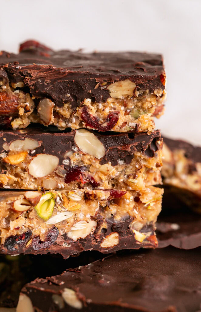 a close up of three trail mix bars stacked on top of each other.
