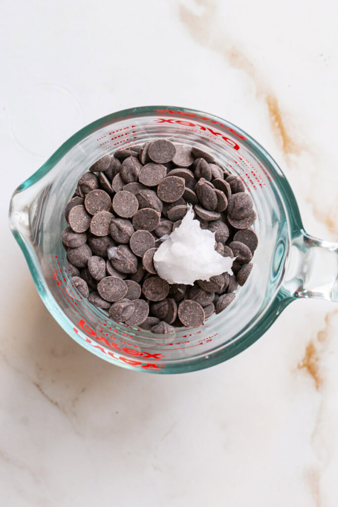 chocolate chips and coconut oil in a glass measuring cup.